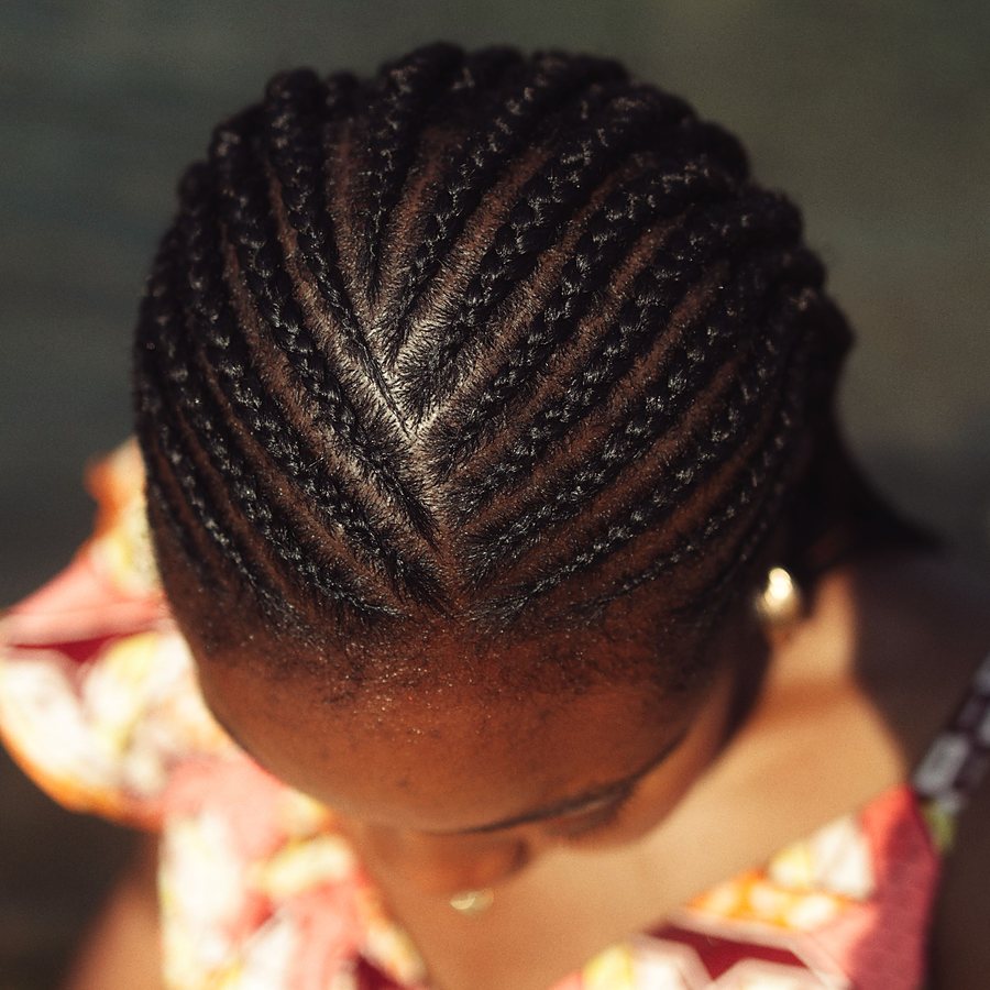 Licensed stock photograph: a cornrow crown seen from above, rows braided back from the hairline.